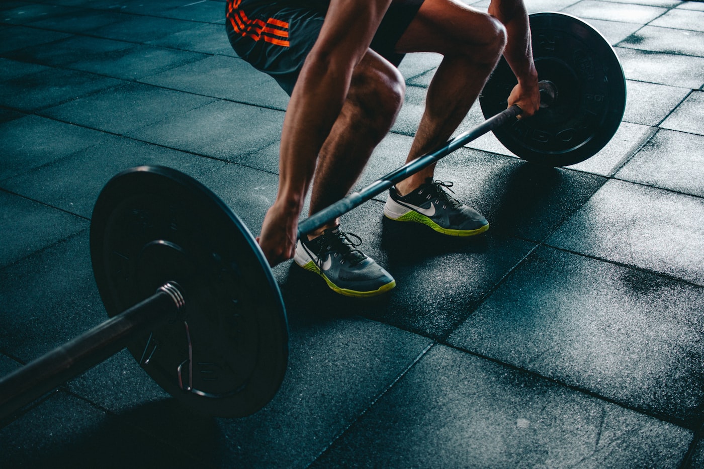Strength floor with barbells, racks and training platforms